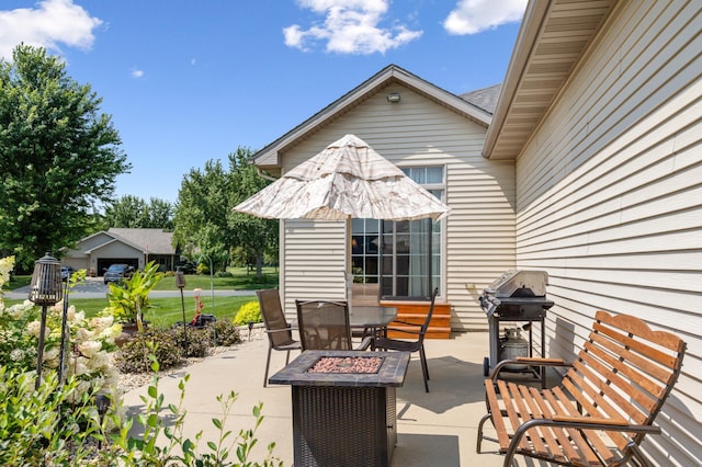 view of patio / terrace with area for grilling and an outdoor fire pit