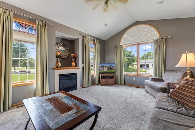 carpeted living room with a healthy amount of sunlight, ceiling fan, and vaulted ceiling