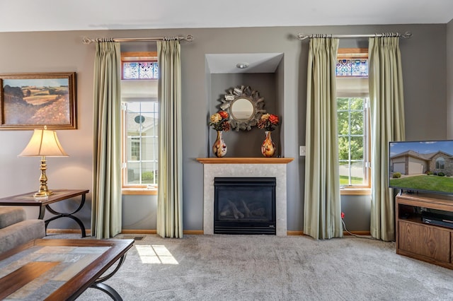 carpeted living room with a tiled fireplace