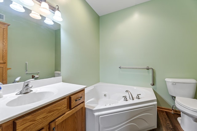 bathroom with toilet, vanity, a bath, and hardwood / wood-style floors