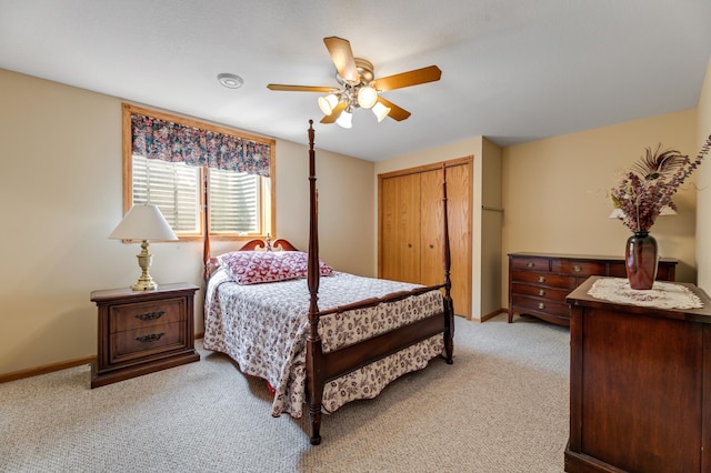 bedroom featuring light colored carpet, a closet, and ceiling fan