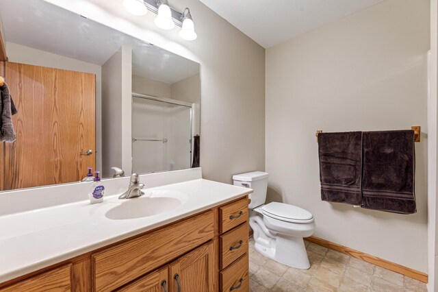 bathroom with vanity, tile patterned flooring, and toilet