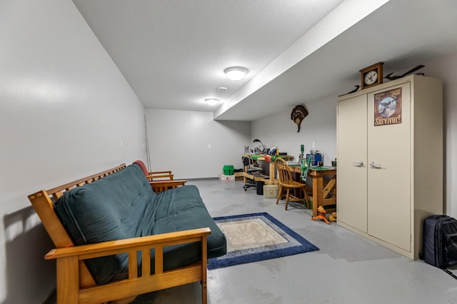 living area featuring concrete floors and a textured ceiling