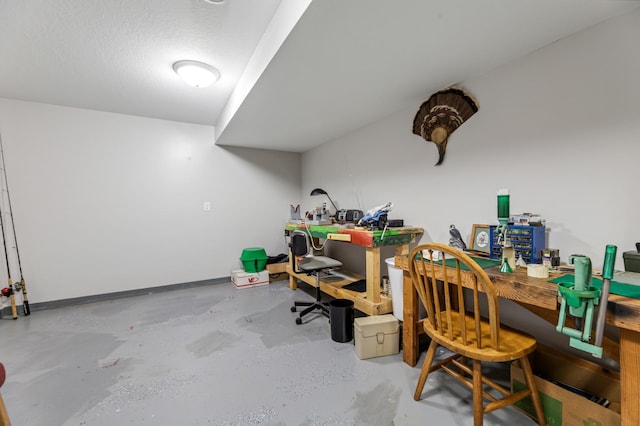 home office with concrete flooring and a textured ceiling