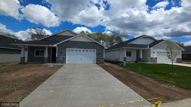 craftsman inspired home with a garage and a front yard