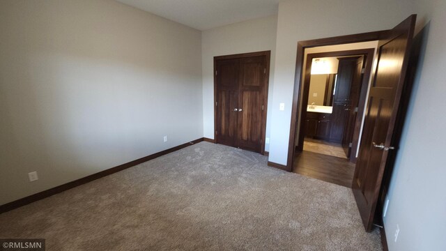 unfurnished bedroom with carpet flooring and ensuite bathroom