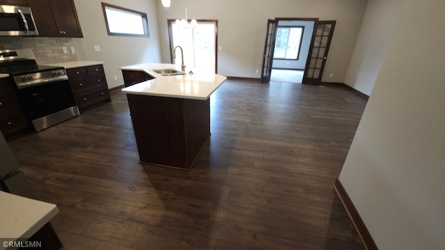 kitchen featuring appliances with stainless steel finishes, sink, dark hardwood / wood-style floors, and tasteful backsplash