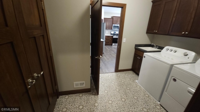 laundry room featuring sink, separate washer and dryer, cabinets, and light tile patterned floors