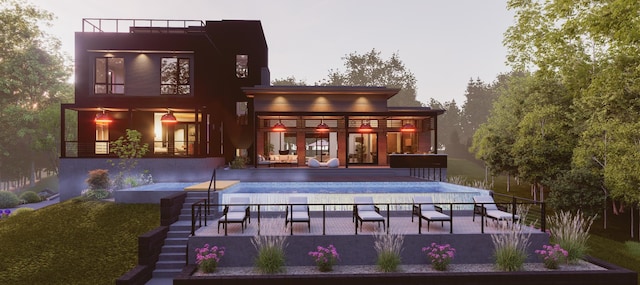 back house at dusk featuring a patio and a balcony