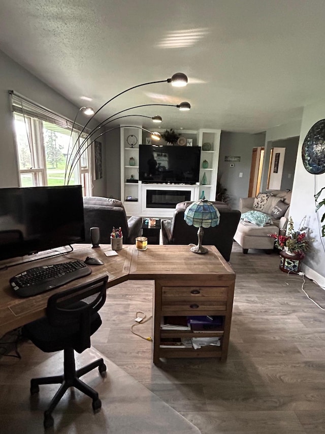 office with a textured ceiling and wood finished floors