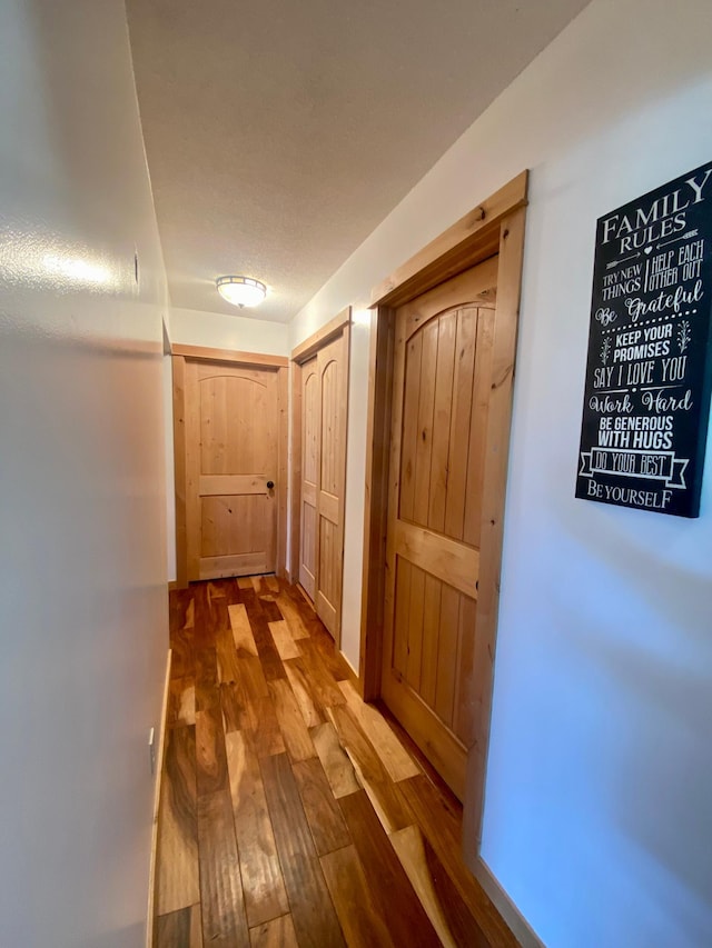 hall with hardwood / wood-style floors