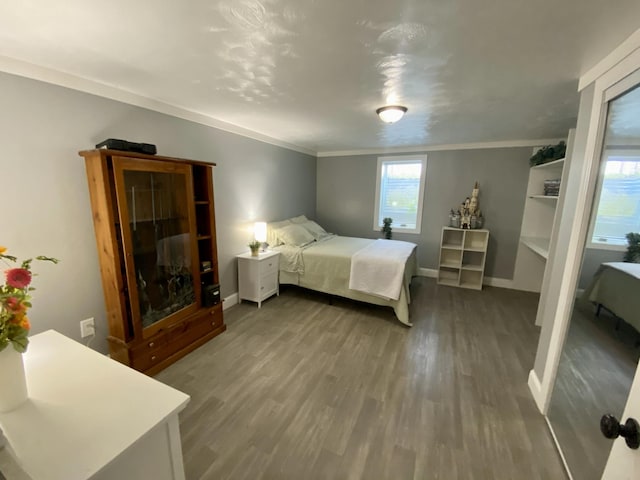 bedroom featuring wood finished floors and baseboards