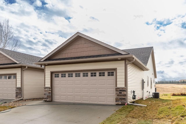 view of front facade with cooling unit and a garage