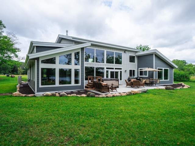 rear view of property with a lawn and a patio area