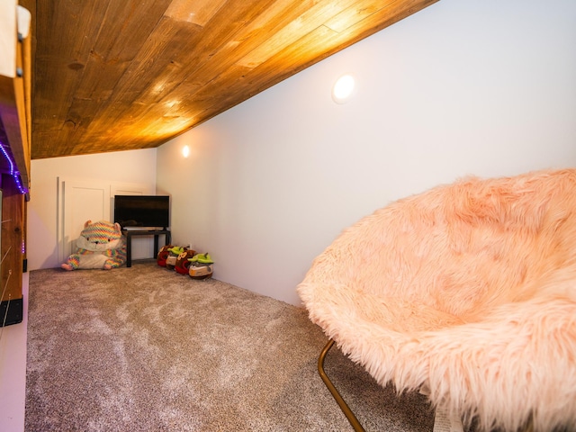 sitting room with wood ceiling, vaulted ceiling, and carpet