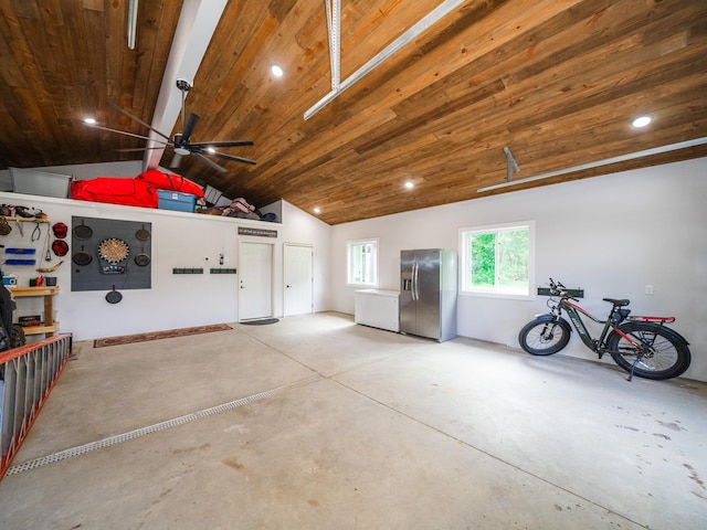 garage with stainless steel refrigerator with ice dispenser and wooden ceiling