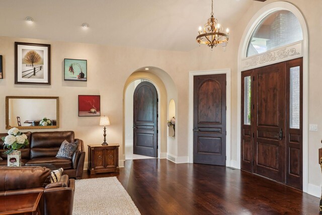 foyer entrance featuring a notable chandelier and dark wood-type flooring