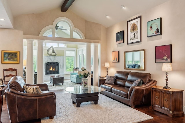 living room featuring a high end fireplace, beam ceiling, dark hardwood / wood-style floors, and high vaulted ceiling