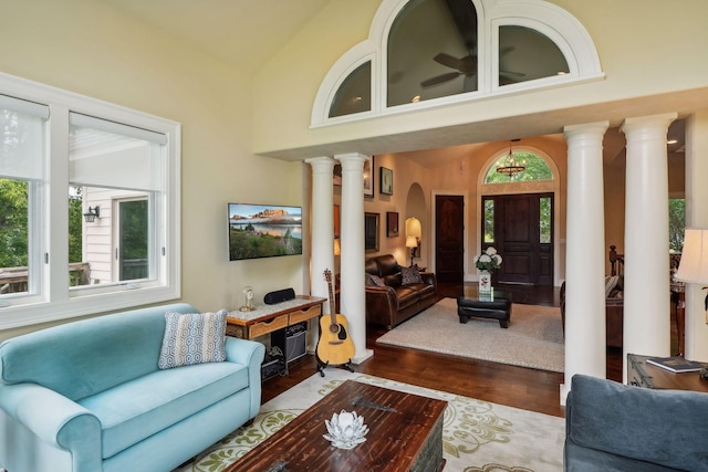 living room featuring plenty of natural light, high vaulted ceiling, and wood-type flooring