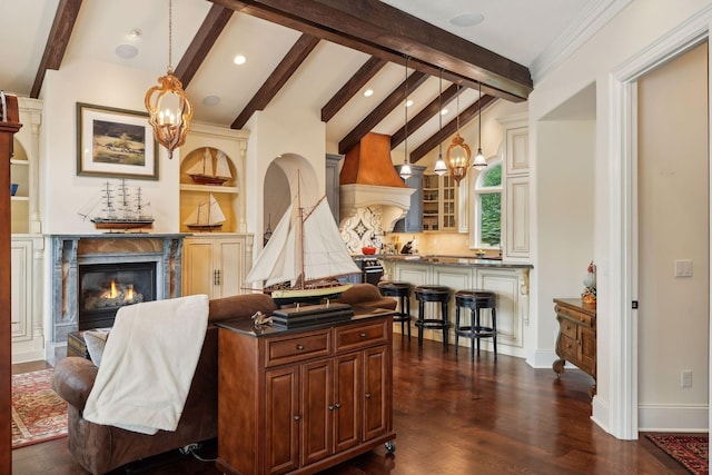 living room featuring lofted ceiling with beams, dark wood-type flooring, a high end fireplace, and an inviting chandelier