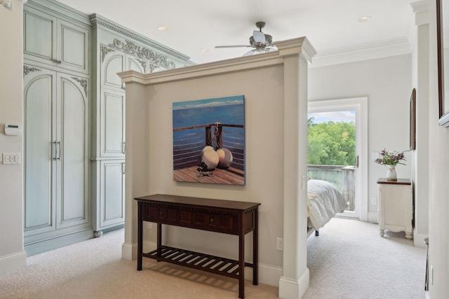 hall with crown molding and light colored carpet