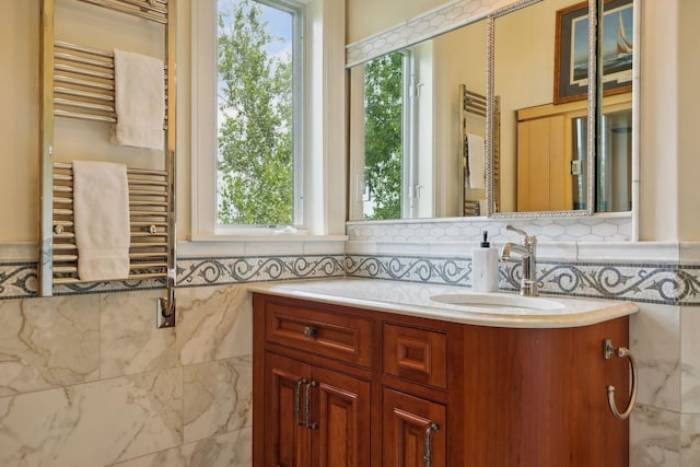 bathroom with tile walls, radiator, and vanity