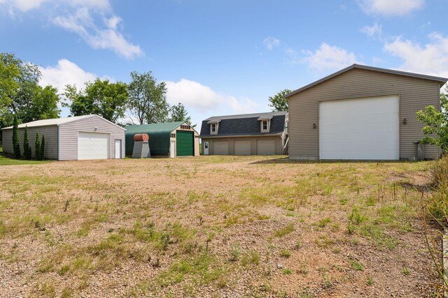 view of yard with an outbuilding and a garage