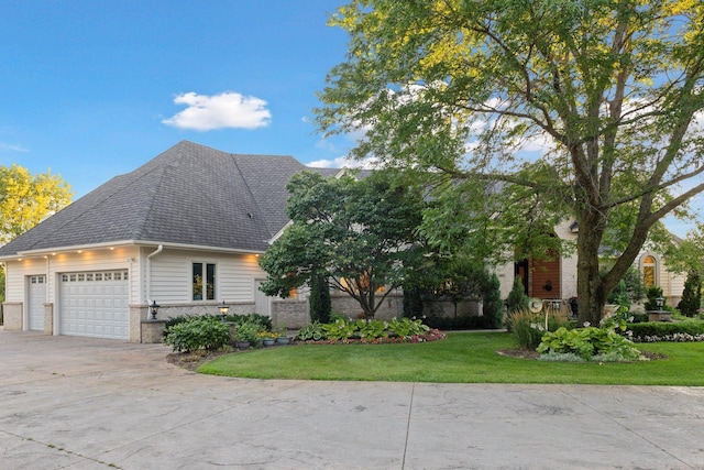 view of front of home with a front lawn and a garage