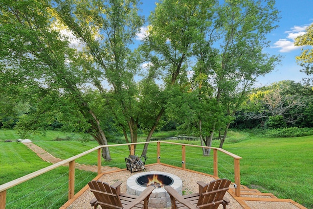 deck with a lawn and an outdoor fire pit