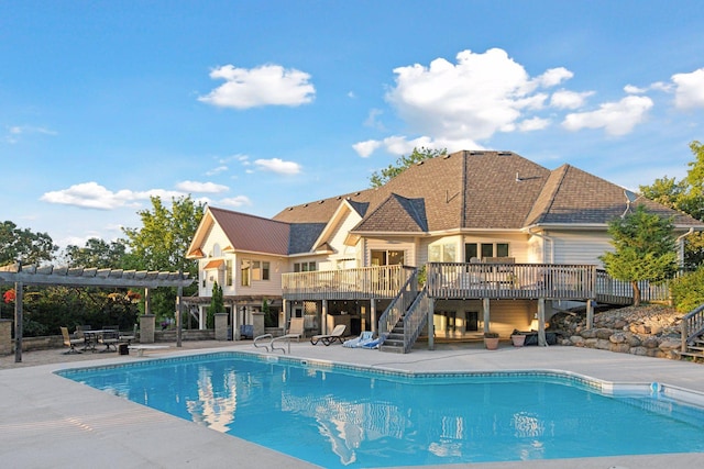 view of pool featuring a patio area, a pergola, and a wooden deck