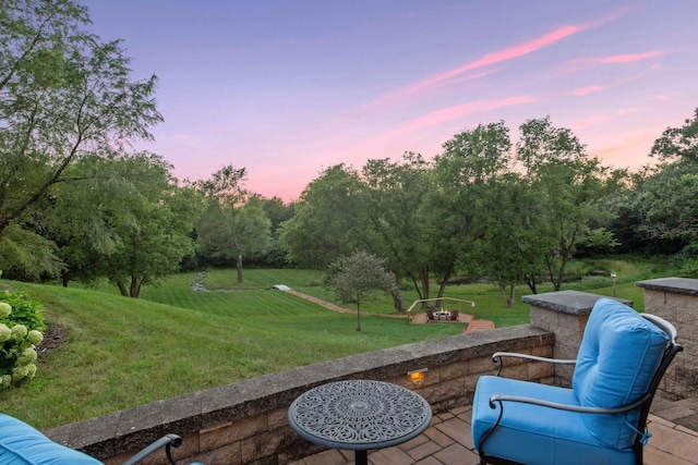 patio terrace at dusk with a lawn and an outdoor hangout area