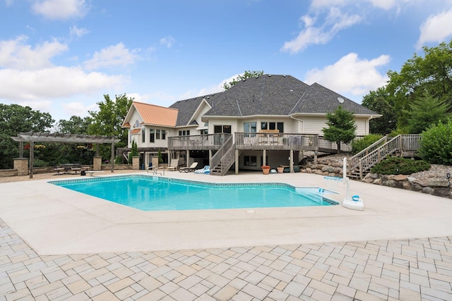 view of swimming pool featuring a patio area, a pergola, and a wooden deck