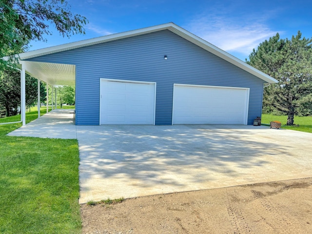 garage with a lawn and a carport