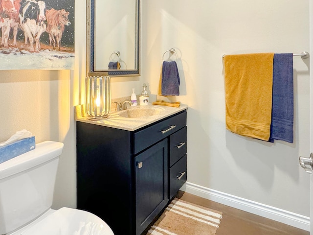 bathroom featuring hardwood / wood-style floors, toilet, and vanity