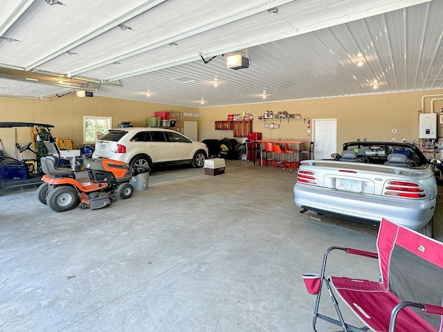 garage with a garage door opener and tankless water heater