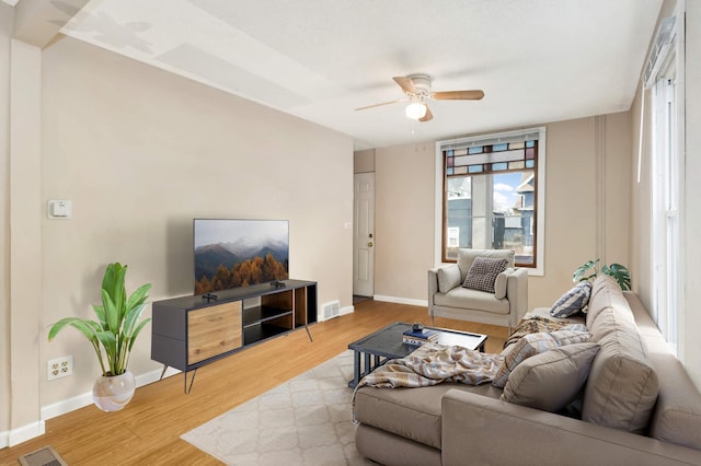 living room with ceiling fan and light wood-type flooring