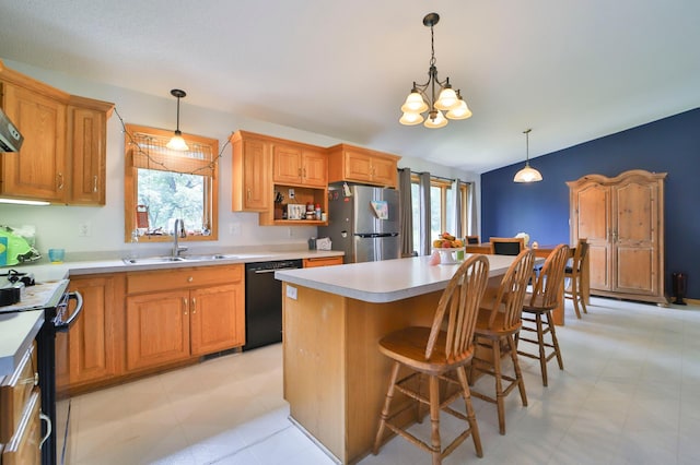 kitchen featuring stainless steel fridge, electric stove, sink, dishwasher, and a center island