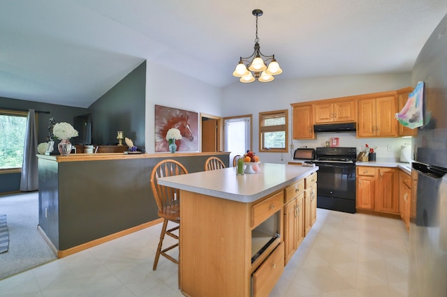 kitchen featuring black electric range oven, hanging light fixtures, lofted ceiling, and a kitchen island