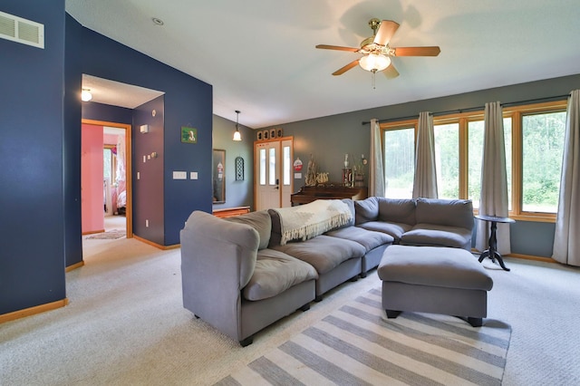 living room with ceiling fan, light colored carpet, and vaulted ceiling