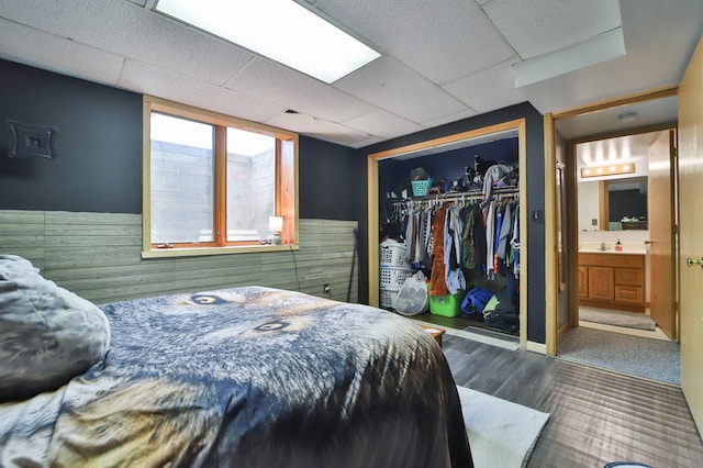 bedroom featuring a closet, dark carpet, and ensuite bathroom