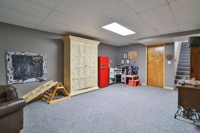 recreation room with a paneled ceiling and carpet floors