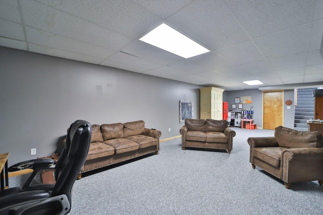 carpeted living room with a paneled ceiling