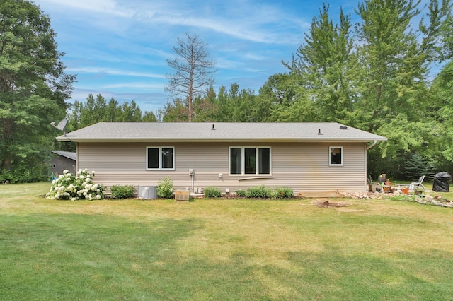 back of house with a lawn and central AC