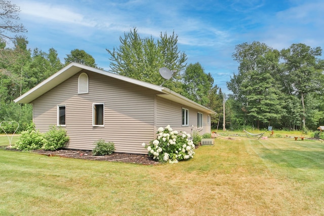 view of property exterior with a lawn