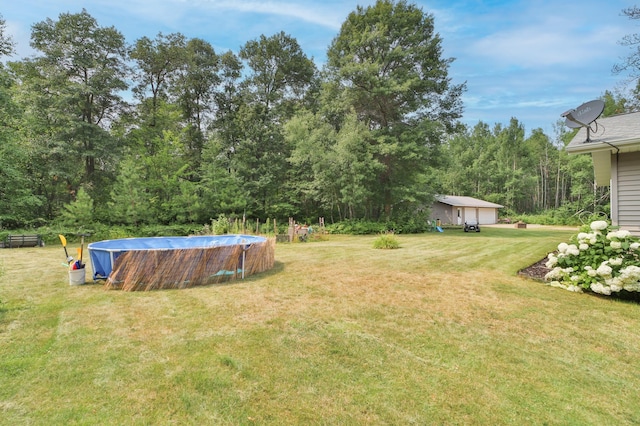 view of yard featuring a covered pool