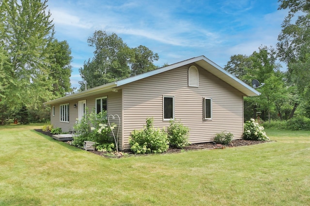 view of side of home featuring a lawn