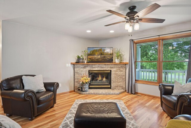 living room with ceiling fan and hardwood / wood-style floors