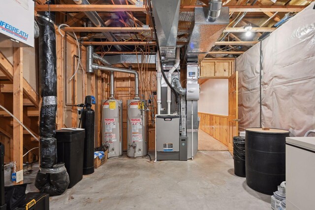 basement with gas water heater and wood walls