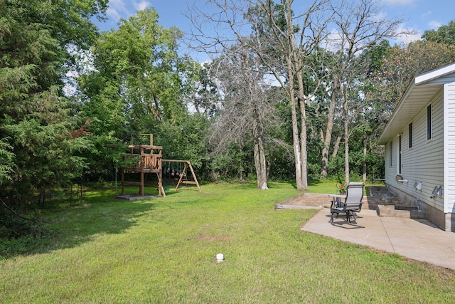 view of yard featuring a playground and a patio area