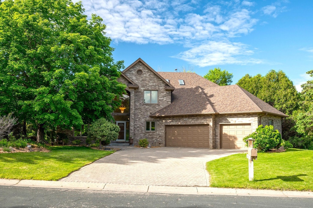 view of front of property with a front lawn and a garage